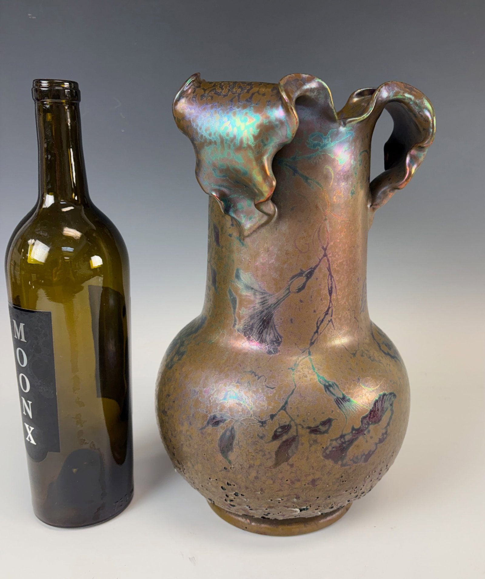 Clement Massier Ceramic Vase Flowers & Tendrils: Clement Massier (France 1844-1917) a fine large vase of bulbous form tapering into a cylindrical waisted body with three separate leaves folded over top rim, green and violet metallic lustre glaze, si