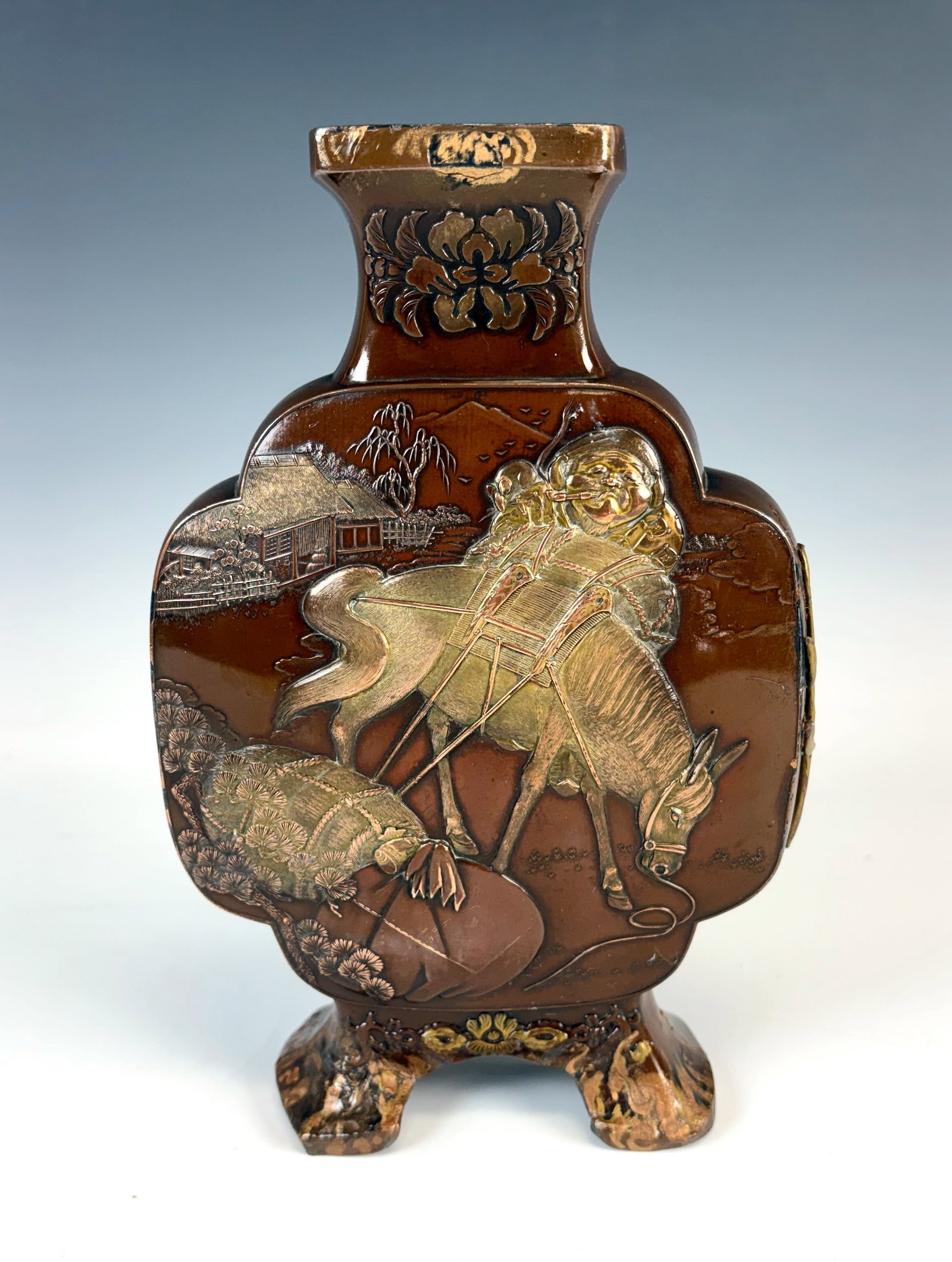 Signed Japanese Mixed Metal Vase w Animals: Meiji period signed vase, circular body having flattened front and back with village scene with a monkey, a fish and a man on horseback, areas of restoration on bottom feet, side and top rim, 9" x 6" 