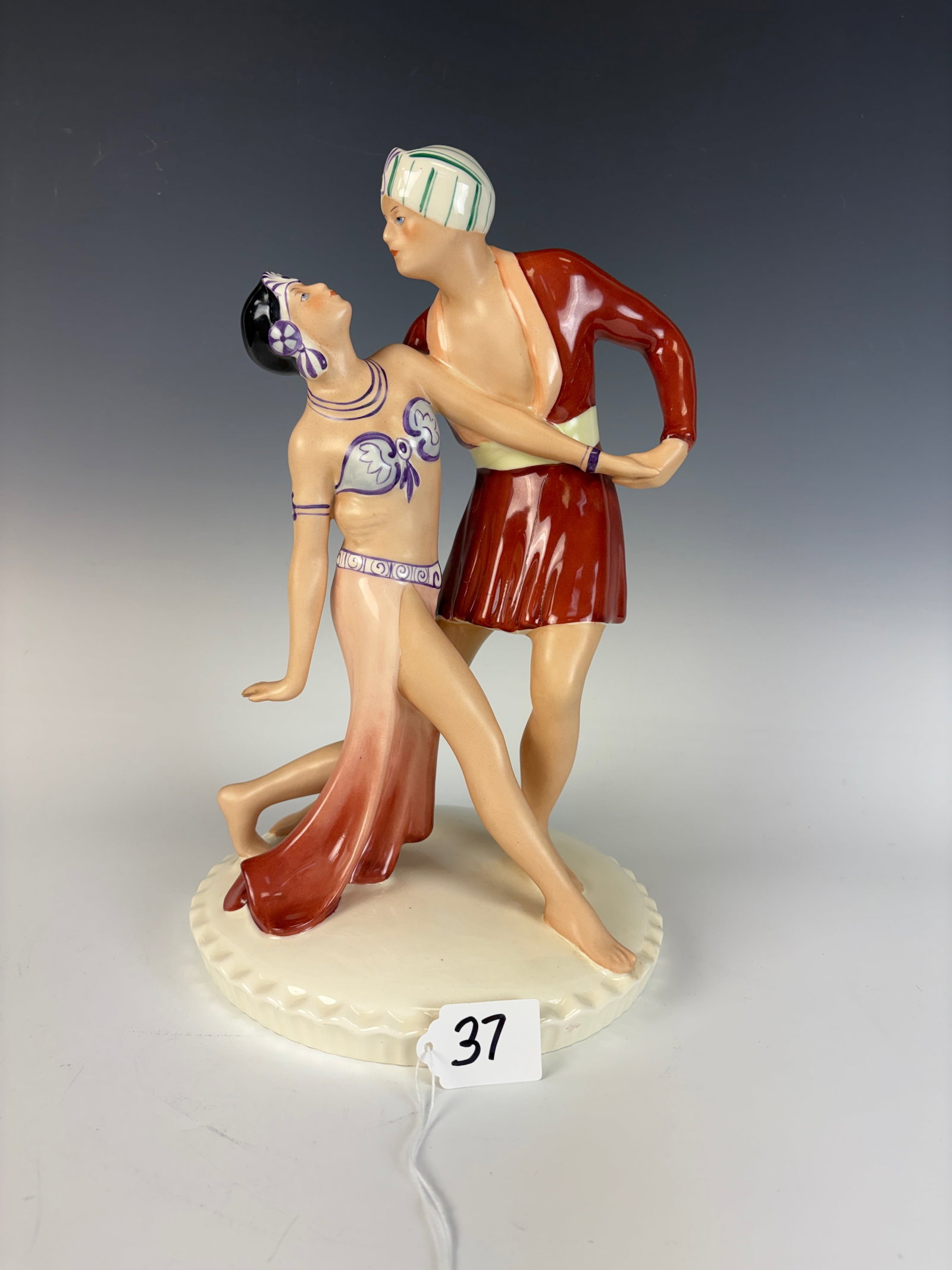 Royal Dux Art Deco Dancers Figurine: A glazed earthenware Art Deco figure depicting an exotic dancing couple, capturing graceful movement and period elegance.13.5” tall × 8” wide × 8” deep. In excellent condition.