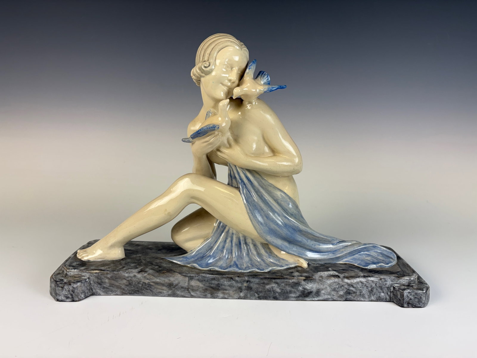 Armand Godard Art Deco Woman with Birds Figurine: Wonderful Art Deco figurine depicting a semi-nude lady accompanied by birds, ceramic, high-glaze finish by Kaza, signed A. Godard. 10” × 4.5” × 4”, excellent condition.