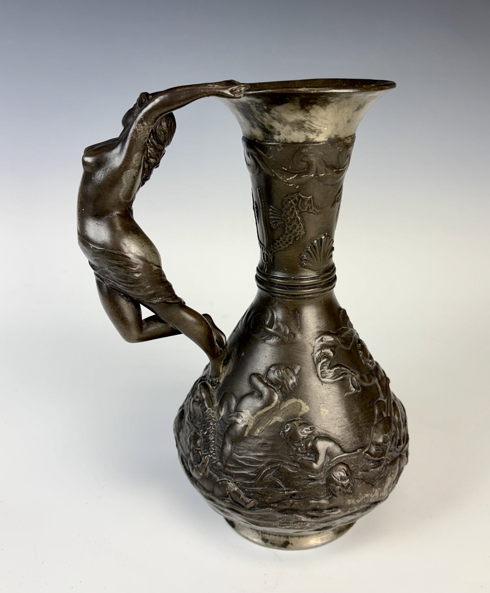 Art Nouveau Handled Ewer w Nude & Putti Sgd Perron: Circa 1900, French, signed "Ch. Perron" and with marks on bottom "Etain Garanti, Paris" art nouveau pewter ewer with handle modeled as a nude figure, with raised relief scene on body with putti and fi