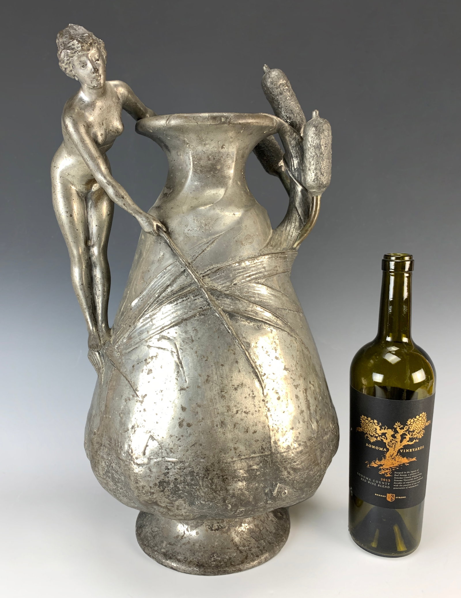Jules Jouant Art Nouveau Pewter Vase w Nude: Jules Jouant (1863-1938) a large wonderful circa 1900 Art Nouveau vase in pewter depicting a nude woman standing on the side of the vase with reeds and cattails. Signed on base Jouant. Size: 20" tall.