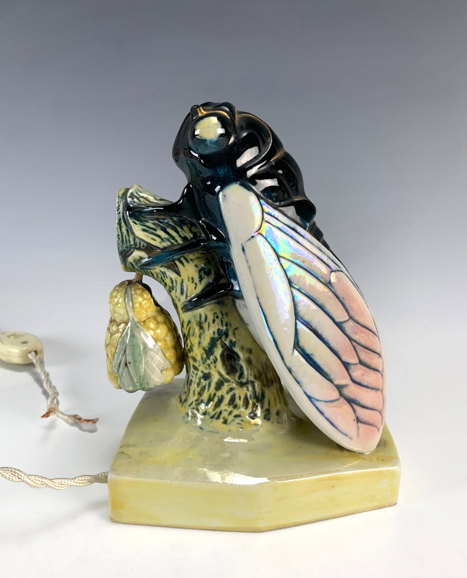 Cicada Figural French Night Light: Circa 1930s. Most unusual French night light of a cicada against a tree stump with a porcelain bell (lamp). It has a red mark forming a circle with the evocation of the map of France in the center. sm
