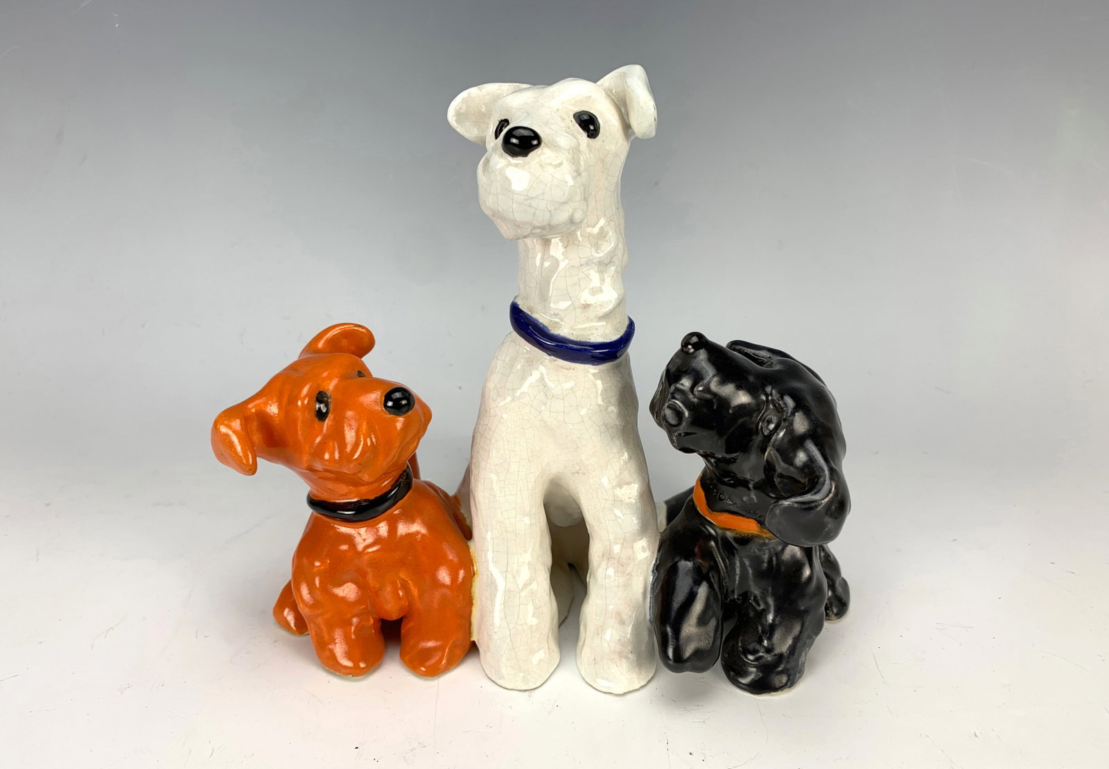Goldscheider Ceramic Figurine w Three Dogs: Charming ceramic figure of three dogs, both small dogs looking up at the bigger one, stamped "Goldscheider", 6.25" x 7" (17cm x 19cm) very good condition*In-house shipping within the U.S. available fo