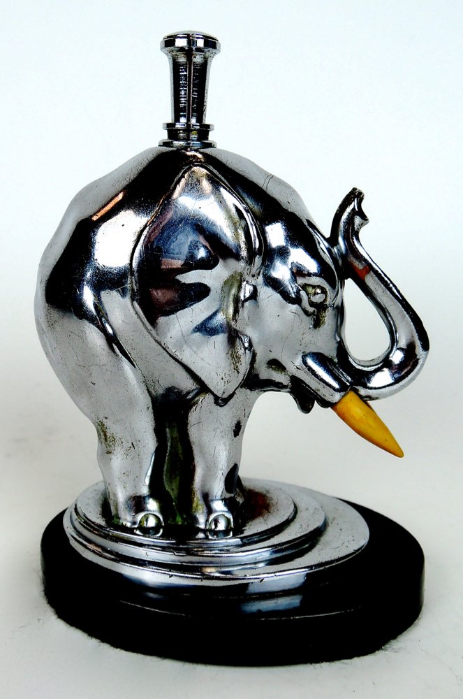 Ronson Elelphant Cigar Lighter: Circa 1950, a chrome modernist cigar lighter modeled as an elephant with upturned trunk having the wand mounted on top and the strike on his trunk, height 5" (12.7 cm) Start Bid $200