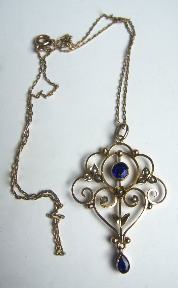 Art Nouveau Pearl Necklace: Edwardian art nouveau pearl and tanzanite pendant and chain, pendant with open scrolls set with seed pearls and bezel set faceted tanzanites, 9 ct gold, chain 18" (46 cm) long, pendant measures 2" (5 