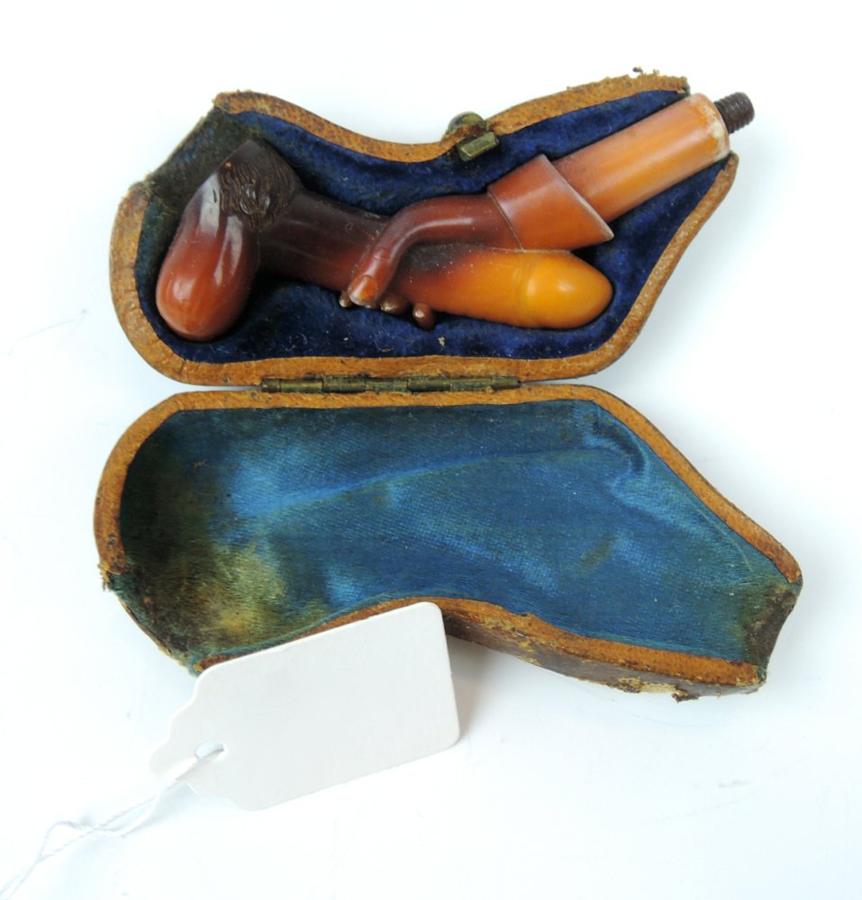 Rare Phallic Erotic Meerschaum Pipe Cigar Holder: Circa 1880, a rare piece of erotica, a hand carved meerschaum cigar holder in fitted case, pipe is in fine condition, case with losses to leather, no amber stem, pipe 3" (7.6 cm) long Start Bid $400