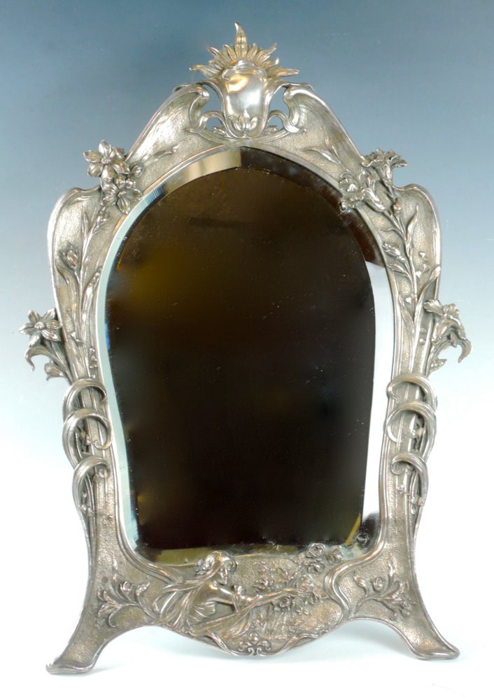 Art Nouveau Silverplate Beveled Dresser Mirror: Circa 1890, marked "Walkers & Hall, Sheffield England" with flag mark, an original and impressive dresser mirror with sculpted details including a maiden with poppies, floral borders and a central sun
