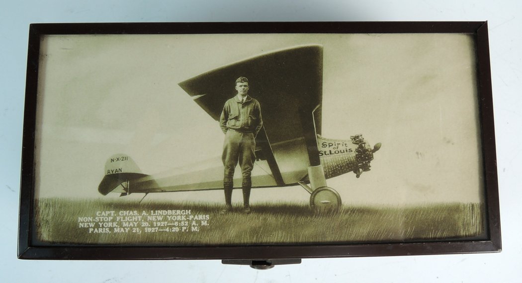 Charles Lindbergh Photograph & Metal Box: Of the period, a photograph of the famous aviator Charles Lindbergh standing beside his plane the "Spirit of St. Louis" with the caption "Capt. Chas. A. Lindbergh-Non Stop Flight, New York to Paris, M
