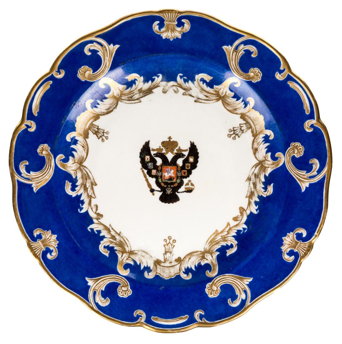 A RUSSIAN IMPERIAL PORCELAIN PLATE, IMPERIAL PORCELAIN: A RUSSIAN IMPERIAL PORCELAIN PLATE, IMPERIAL PORCELAIN FACTORY, ST. PETERSBURG, PERIOD OF EMPEROR NICHOLAS I, CIRCA 1840S the cobalt glazed blue rim decorated with gilded scallops and C-scrolls, the w