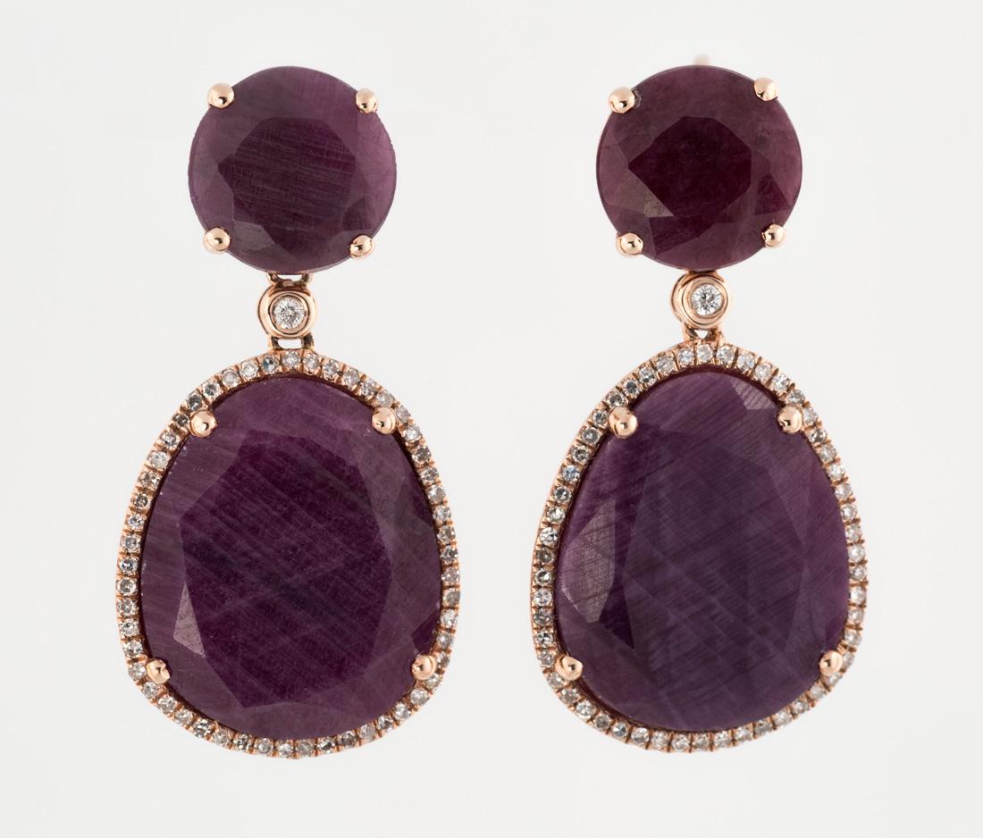 A PAIR OF ROSE GOLD AND RAW RUBY EARRINGS WITH DIAMONDS: A PAIR OF ROSE GOLD AND RAW RUBY EARRINGS WITH DIAMONDS the faceted rubies surrounded by a halo of diamonds, set in rose gold, approximate weight of diamonds: 0.38 carats, approximate weight of rubies