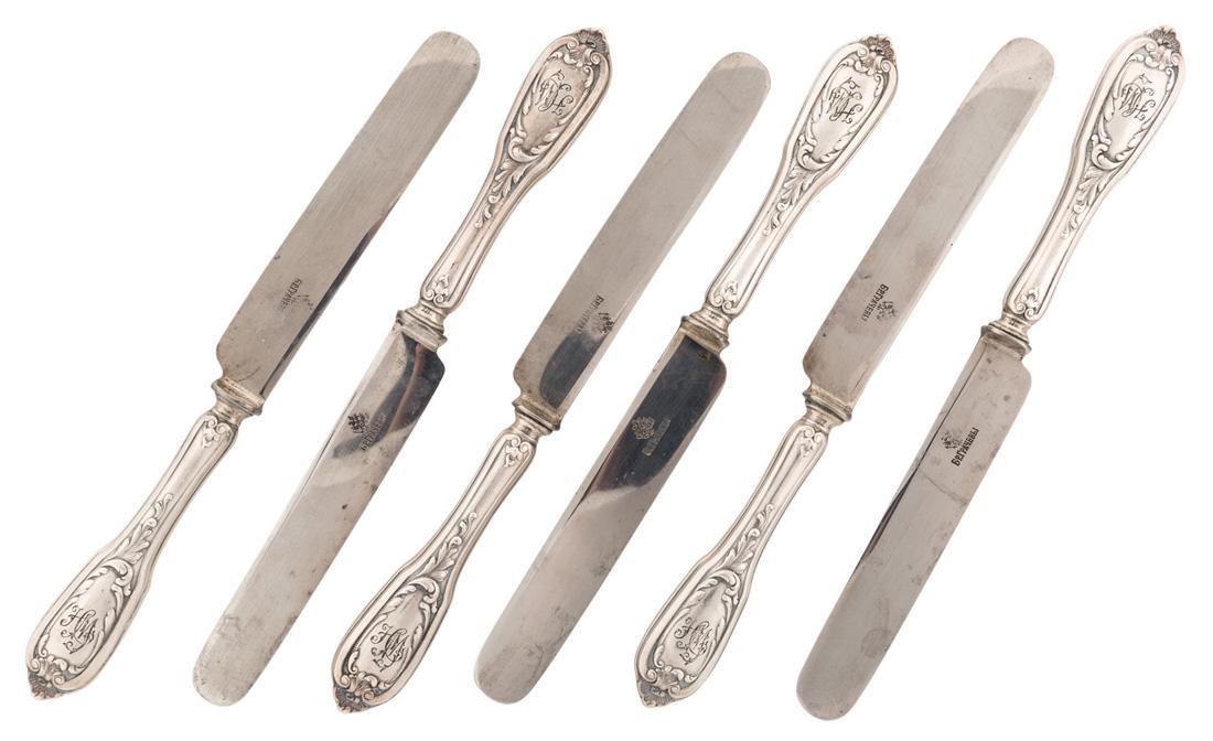 A RUSSIAN SET OF SIX SILVER AND STEEL KNIVES, GRACHEV: A RUSSIAN SET OF SIX SILVER AND STEEL KNIVES, GRACHEV BROTHERS, ST. PETERSBURG, 1908-1917 the silver handles decorated with scrolling leaves in rococo style, the steel blades with Grachev Brothers mar