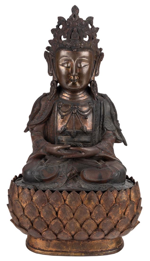 A GILT SINO-TIBETAN BRONZE FIGURE OF A GUANYIN WITH: A GILT SINO-TIBETAN BRONZE FIGURE OF A GUANYIN WITH WOODEN BASE, 19TH CENTURY bronze with red-brown patina, the wood base modelled as a lotus; overall height: 40 cm (15 3/4 in.), height of figure only