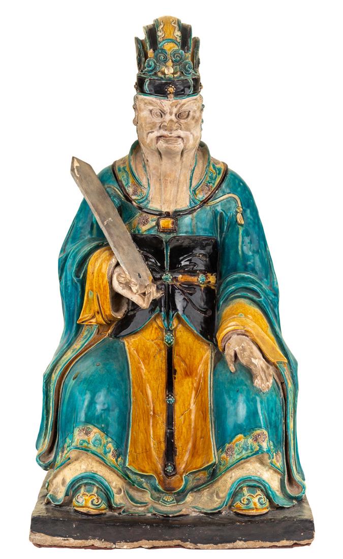 A MONUMENTAL SANCAI-GLAZED FIGURE OF A JUDGE, MING: A MONUMENTAL SANCAI-GLAZED FIGURE OF A JUDGE, MING DYNASTY the judge with a severe expression, holding a tablet in his right hand, dressed in turquoise and ochre robes, seated on a bench, atop a recta