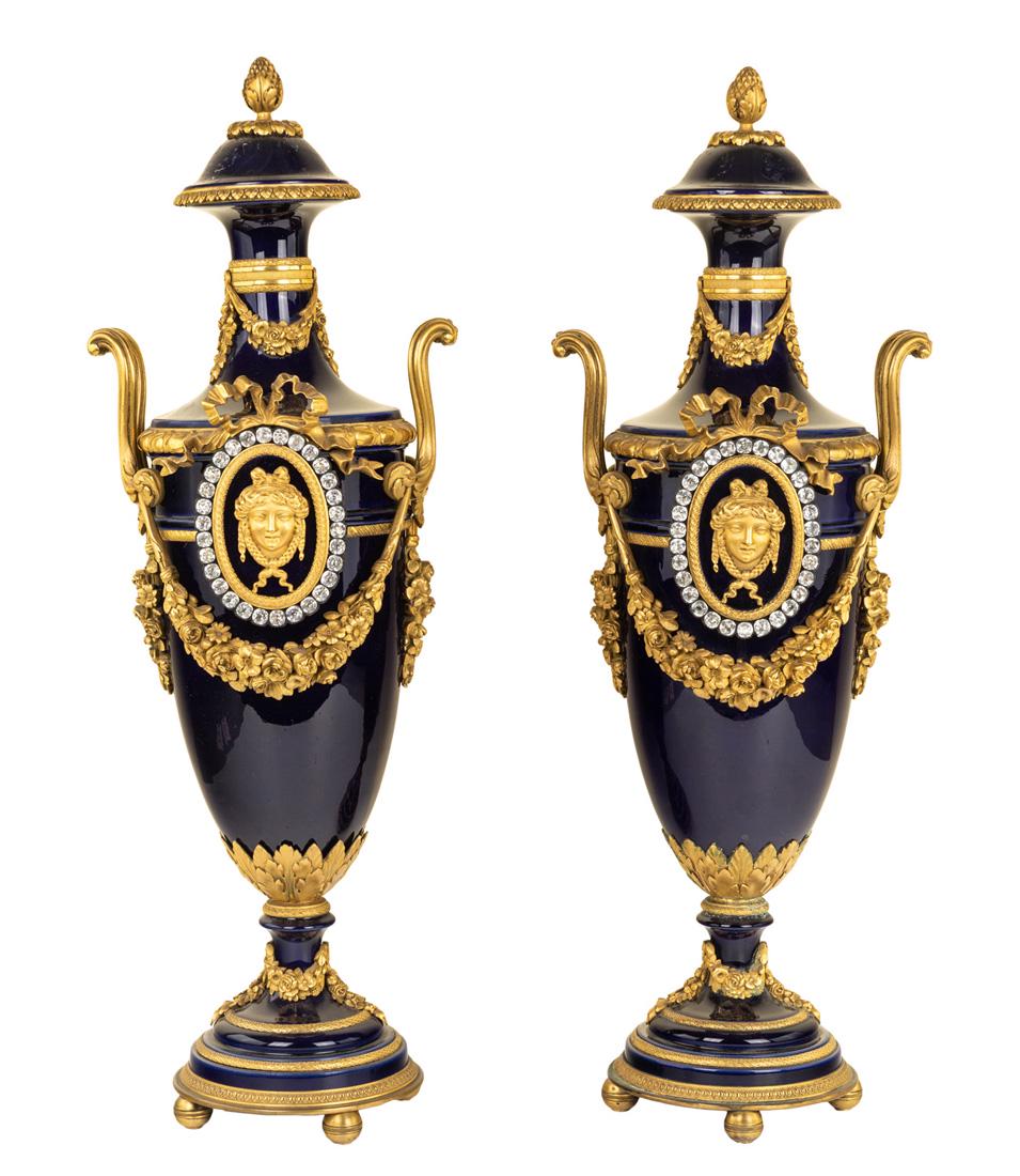 A PAIR OF FRENCH SEVRES-STYLE ORMOLU-MOUNTED VASES,: A PAIR OF FRENCH SEVRES-STYLE ORMOLU-MOUNTED VASES, LATE 19TH CENTURY oviform, the cobalt hard-paste bodies with Louis XVI-style gilt mounts, with domed covers terminating in pinecone finials, sloping