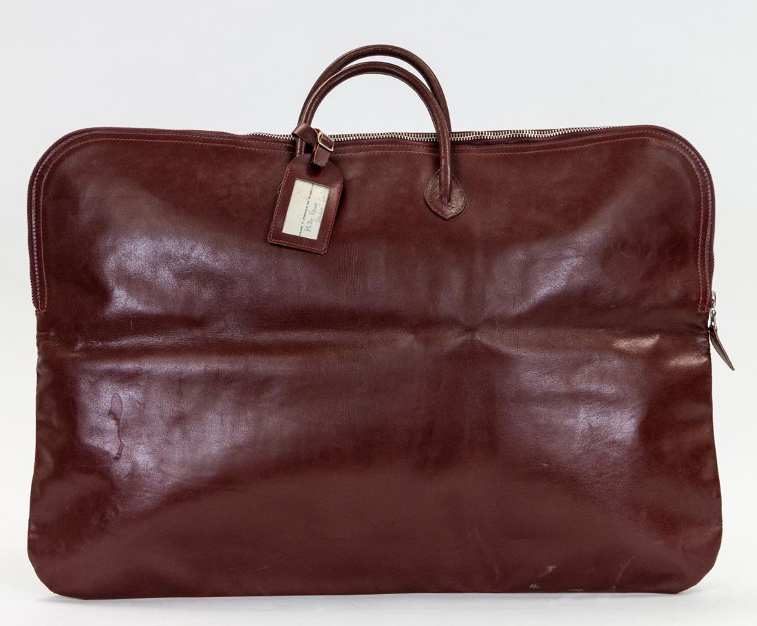 A HERMES BOLIDE-STYLE LEATHER TRAVEL BAG, CIRCA 1930S: A HERMES BOLIDE-STYLE LEATHER TRAVEL BAG, CIRCA 1930S claret-red leather with palladium hardware, includes name tag; overall dimensions: 44 x 64 cm (17 3/8 x 25 1/4 in.)