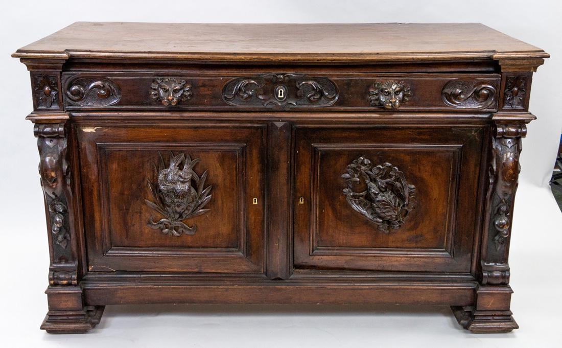 A RENAISSANCE REVIVAL WOODEN COMMODE, EARLY 20TH: A RENAISSANCE REVIVAL WOODEN COMMODE, EARLY 20TH CENTURY rectangular, on four feet, carved with birds flanked by grape bunches, the apron with lion's heads; overall dimensions: 95 (h) x 155.5 (w) x 70