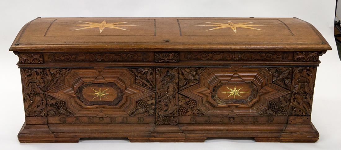 A LARGE WOODEN CHEST, 19TH CENTURY: A LARGE WOODEN CHEST, 19TH CENTURY the top and front featuring pairs of eight-pointed stars, the front featuring a carved frieze with bird, grape, and scrolling acanthus leaf motifs, with bronze garni
