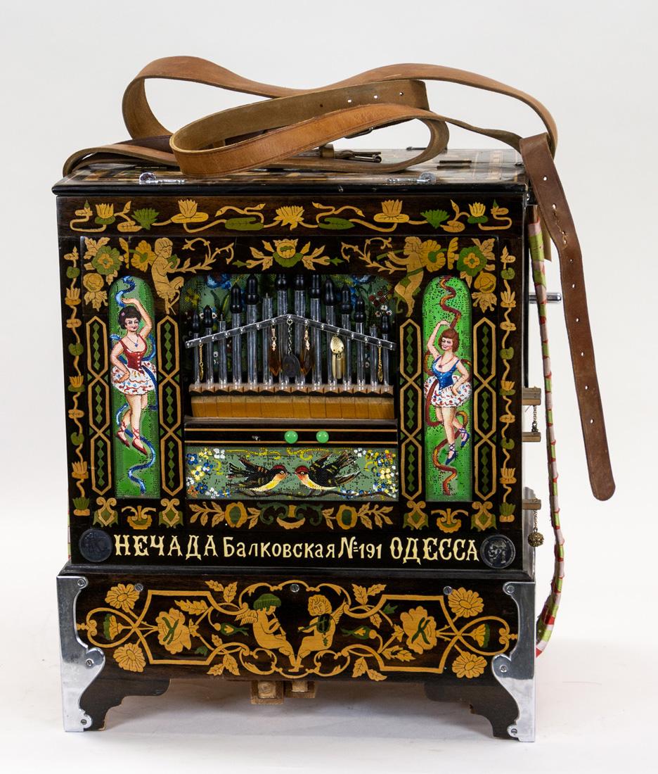 A BARREL ORGAN, ODESSA, LAST QUARTER OF 20TH CENTURY: A BARREL ORGAN, ODESSA, LAST QUARTER OF 20TH CENTURY the front two mesh panels painted, the body with marquetry featuring satyrs and flower motifs, as well as a pair of men and young girl with sheep, 