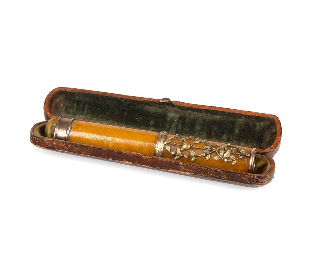 A RUSSIAN GOLD AND DIAMOND-MOUNTED ENAMEL CIGARETTE: A RUSSIAN GOLD AND DIAMOND-MOUNTED ENAMEL CIGARETTE HOLDER, WORKMASTER ALEXANDER WILSON, RIGA, 1882-1903 enamelled overall in ochre yellow, the upper part of the body with interlacing flower swags mou