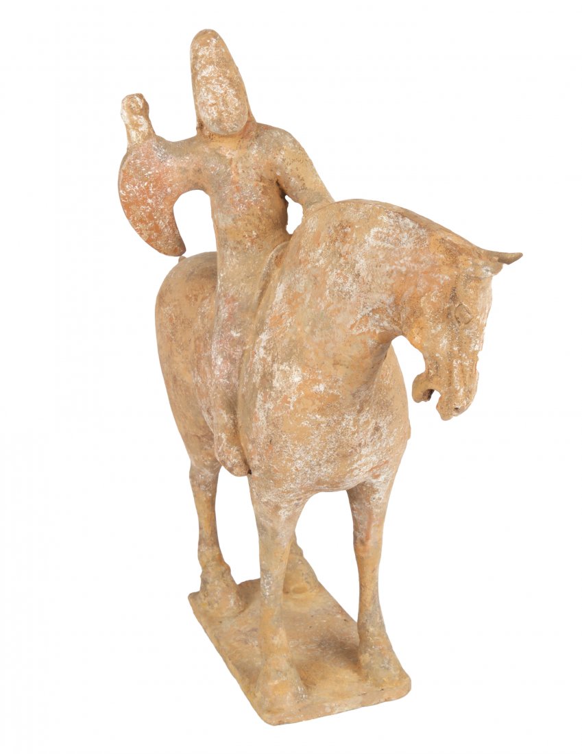 A CHINESE TERRACOTTA FIGURE OF A HORSERIDER, HAN: A CHINESE TERRACOTTA FIGURE OF A HORSERIDER, HAN DYNASTY (206 BC-220 BCE) depicting a horse and rider with raised hands and articulated sleeves, atop flat rectangular base; overall height: 42.5 cm (16