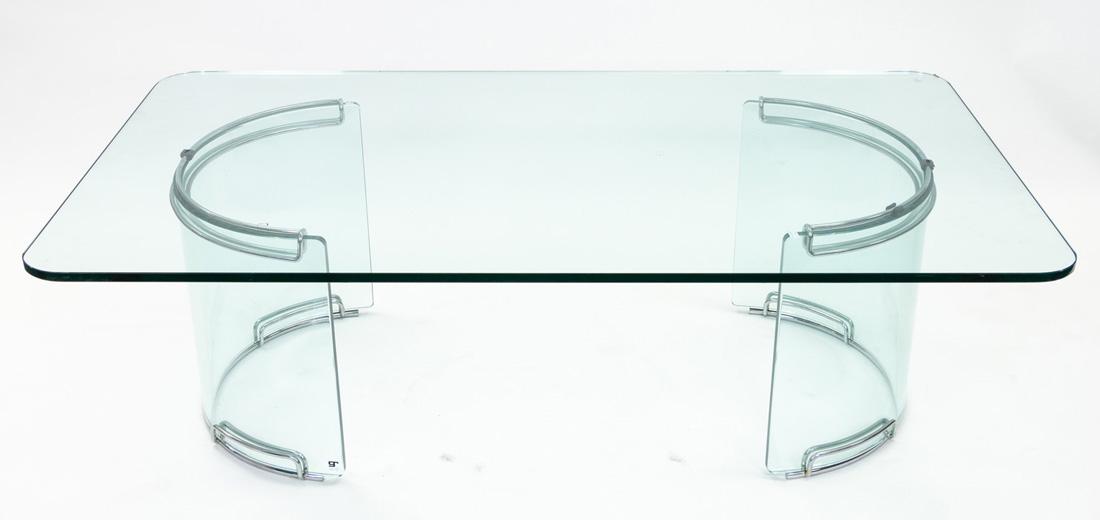 A GALOTTI & RADIS GLASS COFFEE TABLE: A GALOTTI & RADIS GLASS COFFEE TABLE with 14mm transparent glass top, on glass base with chromed aluminium parts; overall dimensions: 140 x 80 x 43.4 cm (55 1/8 x 31 1/2 x 17 1/8 in.)