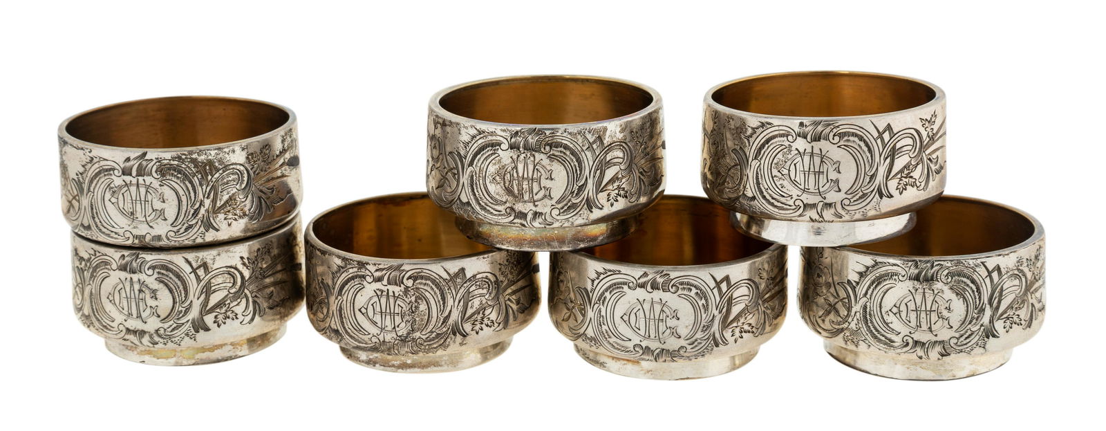 SET OF SEVEN RUSSIAN STACKABLE SILVER CUPS stackable: SET OF SEVEN RUSSIAN STACKABLE SILVER CUPS stackable silver cups with initials in acanthus leaf motifs, silver, small Chinese engraving on bottom; height: 2.54 cm ( 1 in.)