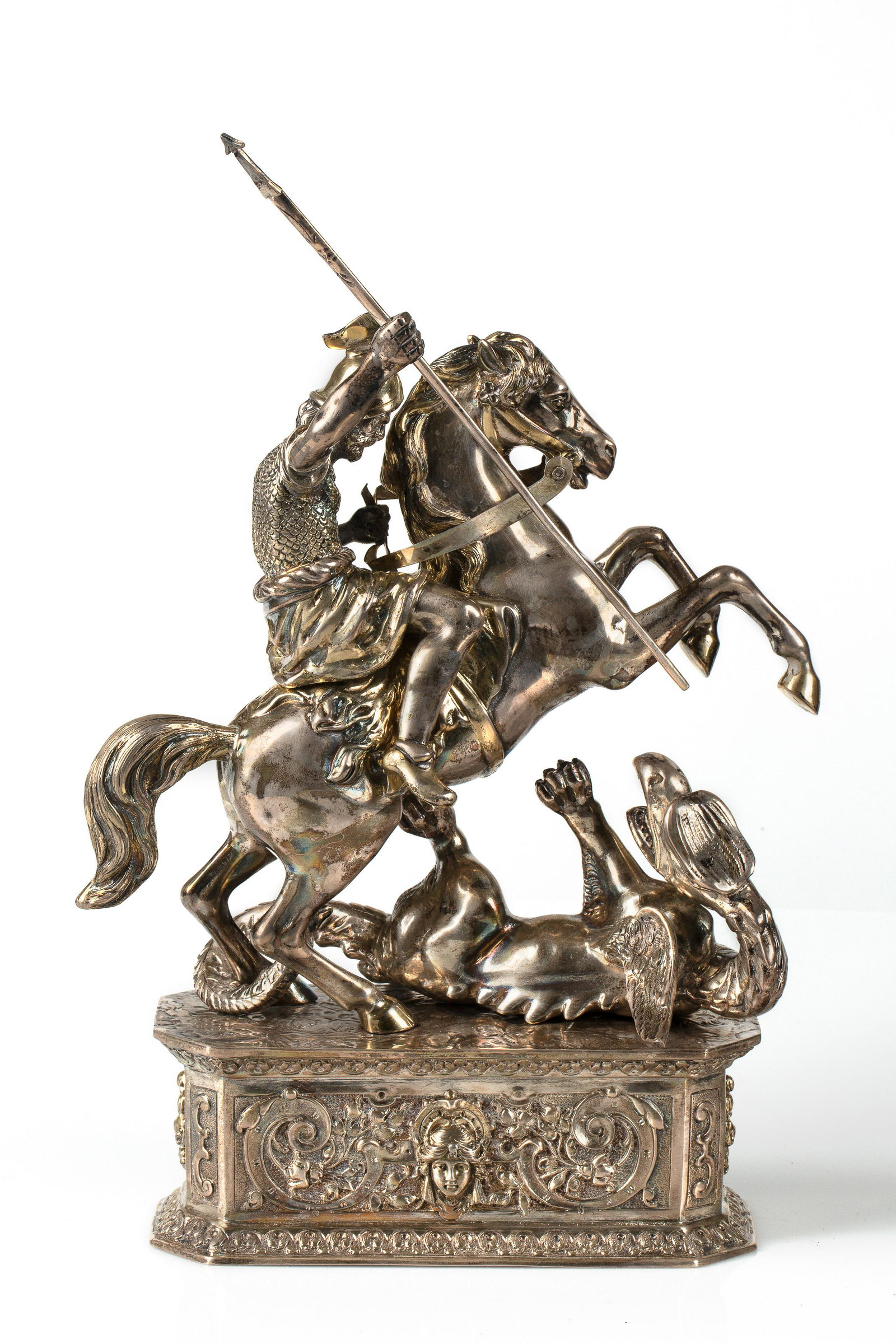A EUROPEAN SILVER FIGURE OF ST. GEORGE SLAYING: A EUROPEAN SILVER FIGURE OF ST. GEORGE SLAYING THE DRAGON, LATE 19TH-EARLY 20TH CENTURY depicting St. George on horseback slaying the Dragon, atop oblong rectangular base with scrolling acanthus and p