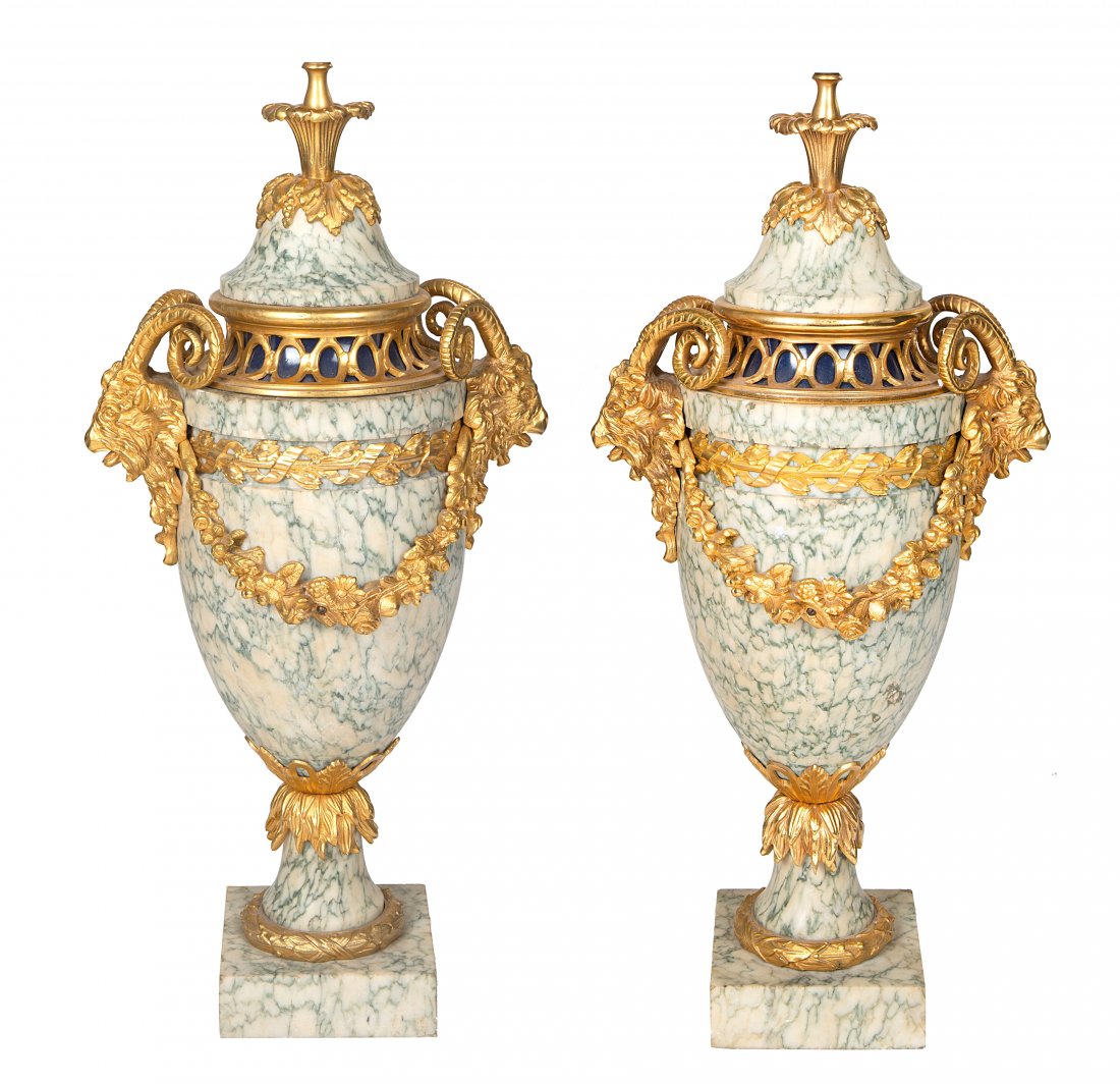 A PAIR OF FRENCH LOUIS XVI STYLE ORMOLU-MOUNTED MARBLE: A PAIR OF FRENCH LOUIS XVI STYLE ORMOLU-MOUNTED MARBLE URNS, LATE 19TH CENTURY WITH LATER LAMP MOUNTS each of narrow ovoid form in white marble, two-handled, the handles formed as goat heads, with sus