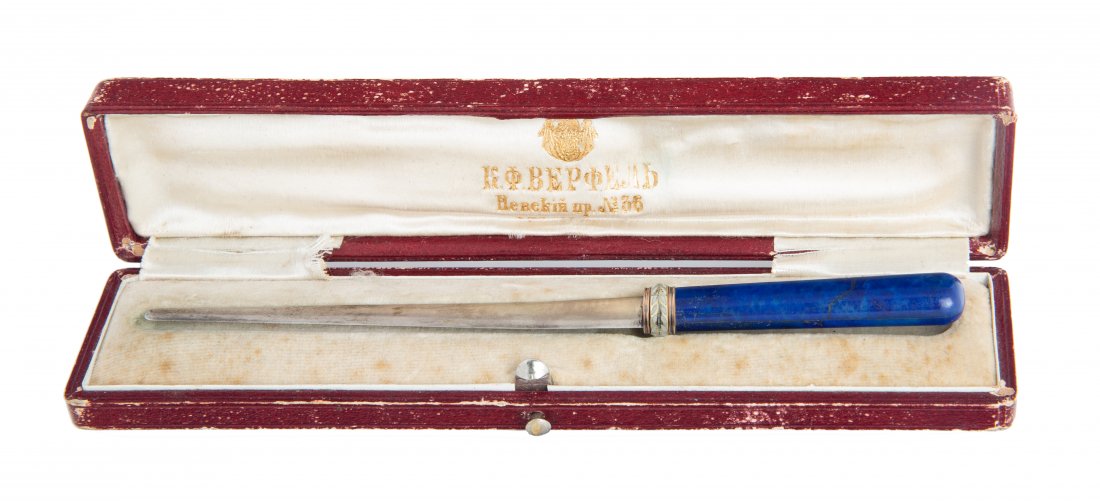 A FABERGE SILVER-MOUNTED LAPIS LAZULI LETTER OPENER,: A FABERGE SILVER-MOUNTED LAPIS LAZULI LETTER OPENER, ST. PETERSBURG, 1896-1908 the handle in lapis lazuli, joined to the blade with a continuous enamelled laurel wreath, the blade marked with 88 stand