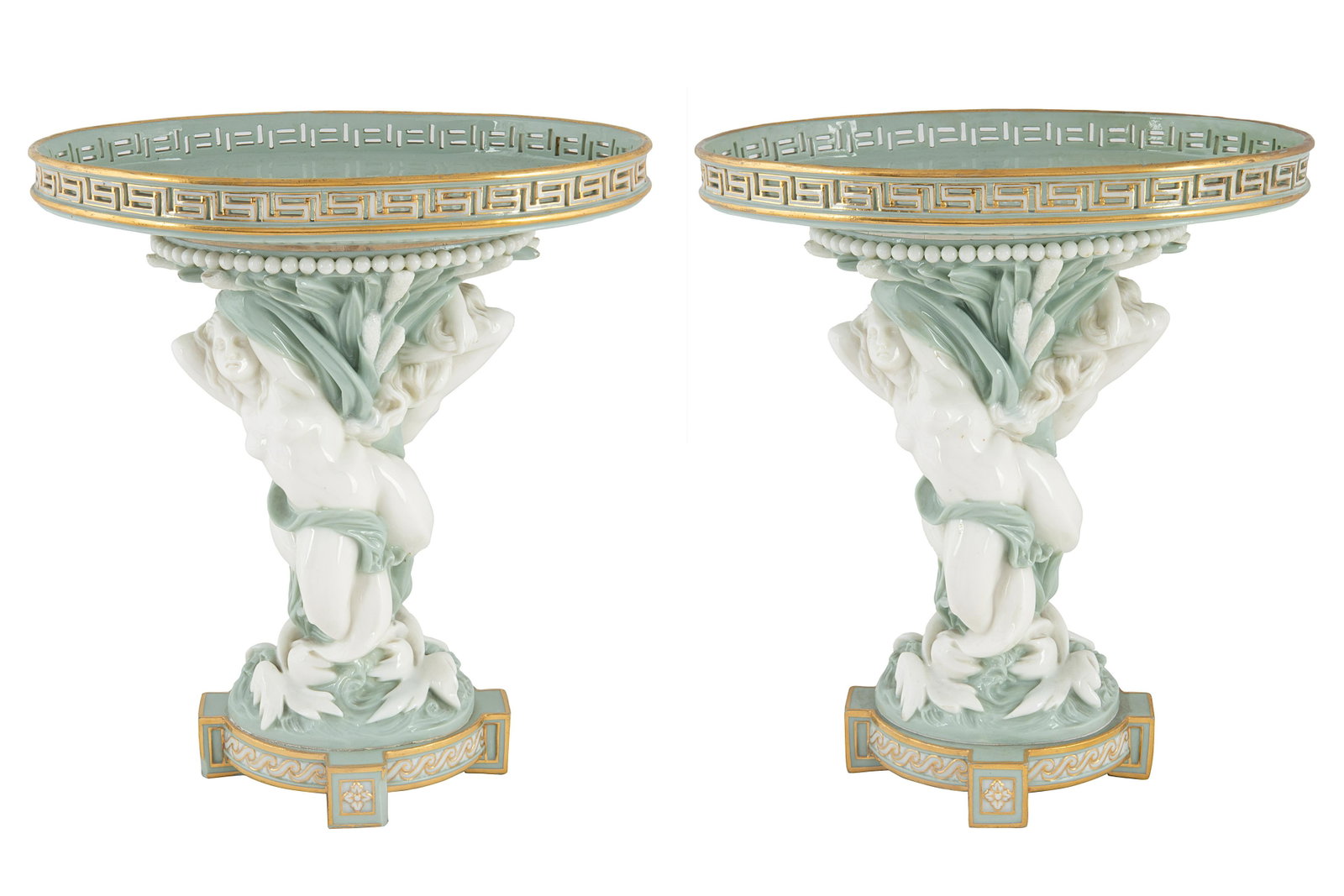 A PAIR OF BRITISH MAJOLICA COMPOTES: A PAIR OF BRITISH MAJOLICA 'SIREN' COMPOTES, MINTONS, STOKE-UPON-TRENT, 1867 each oval, with pierced meander and beaded borders, supported by a pair of twisting sirens within bulrush, glazed in seafoa