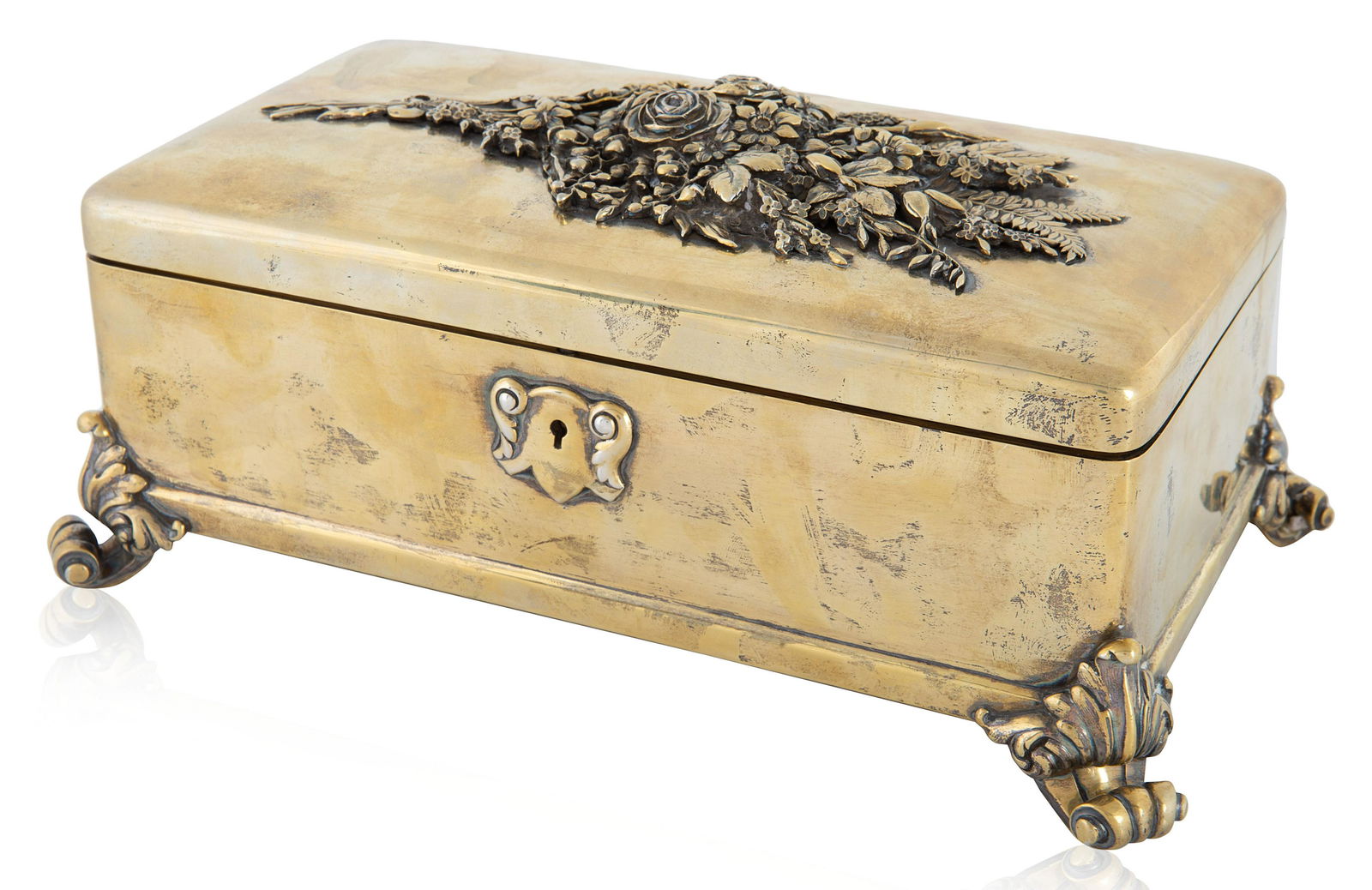 A RUSSIAN GILT SILVER BOX, GRACHEV, ST. PETERSBURG: A RUSSIAN GILT SILVER BOX, GRACHEV, ST. PETERSBURG, 1893 of rectangular form with rounded corners, on tapered scroll feet with acanthus leaves, centered with a wild flower bouquet with ferns, rosettes
