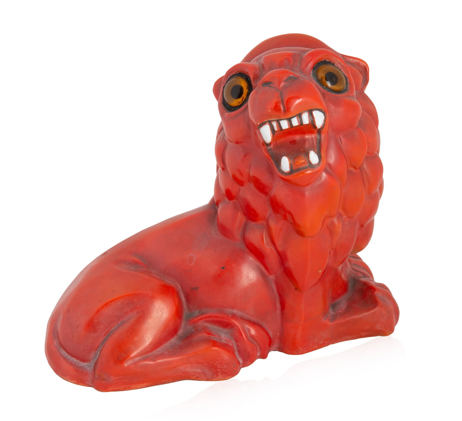 AN ITALIAN PORCELAIN CANDLE COVER, CAPODIMONTE,: AN ITALIAN PORCELAIN CANDLE COVER, CAPODIMONTE, 1830-1890 formed as a seated red lion, with bared fangs and wide eyes, the eyes formed from two glass circles with yellow tint, which glow when lit from