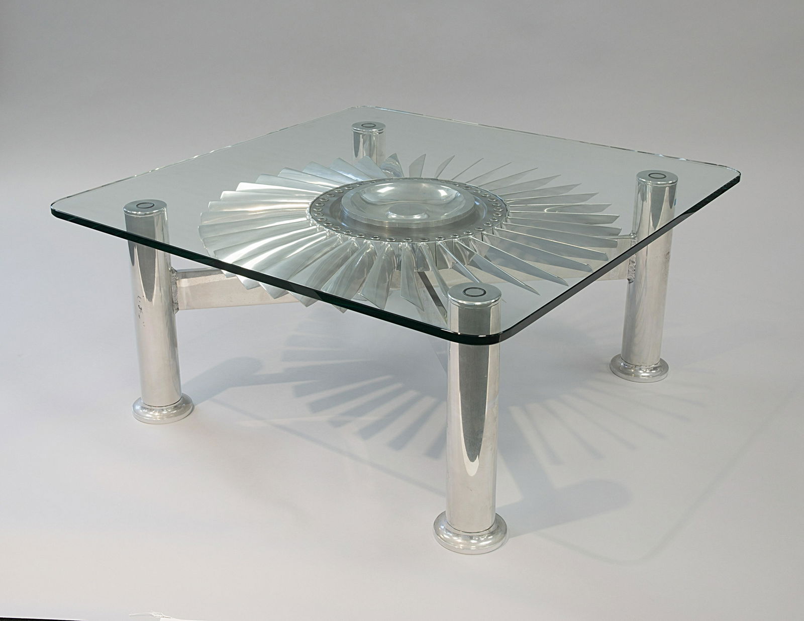 A MODERN STAINLESS STEEL AND GLASS TABLE FEATURING A (1 of 1)