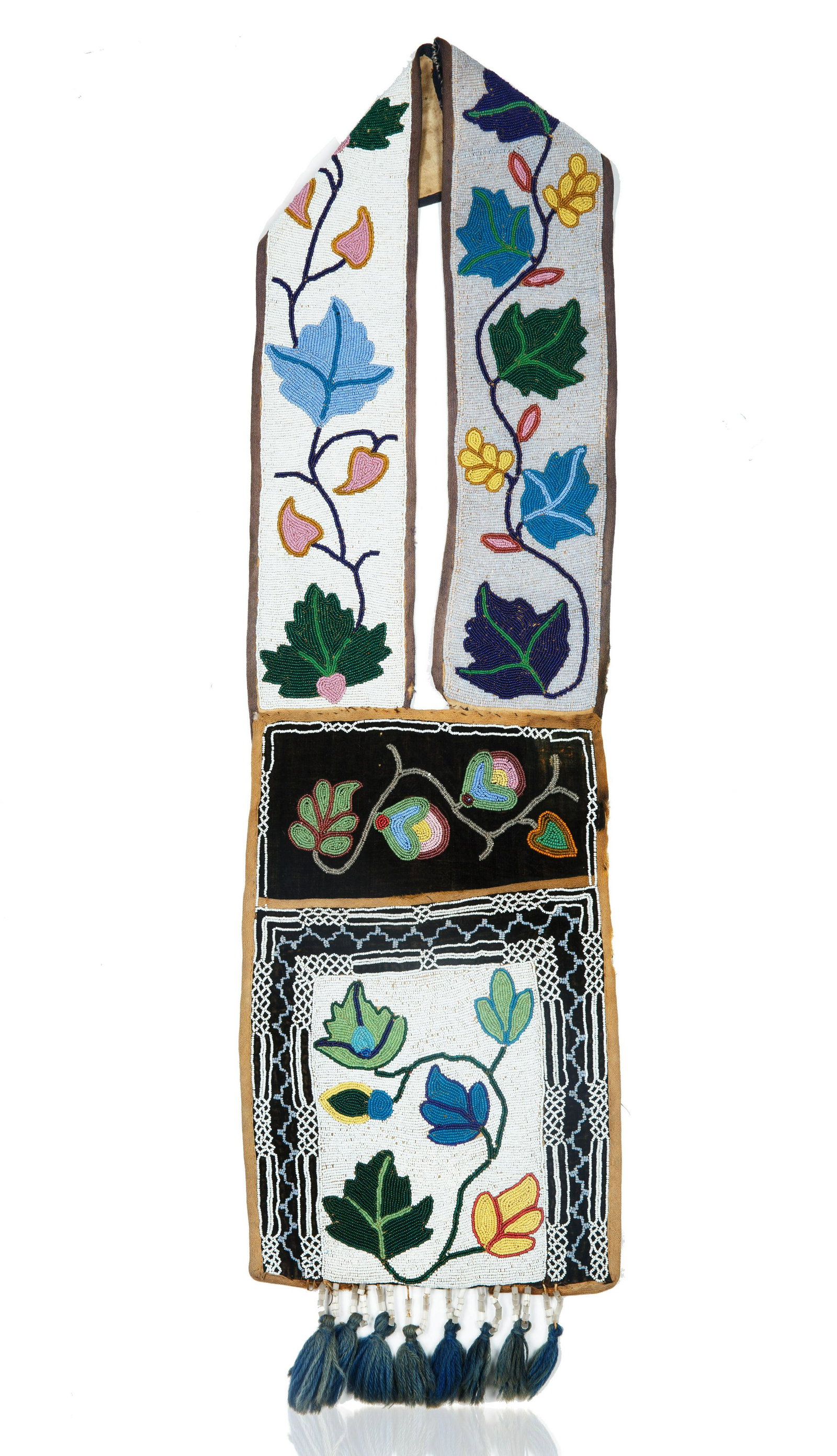 LATE 19TH CENTURY OJIBWA BEADED BANDOLIER BAG: LATE 19TH CENTURY OJIBWA BEADED BANDOLIER BAG executed in applique or spot stitch, with colorful and complex flowering design representing berries, wild roses and more stylized flowers and leaves, the