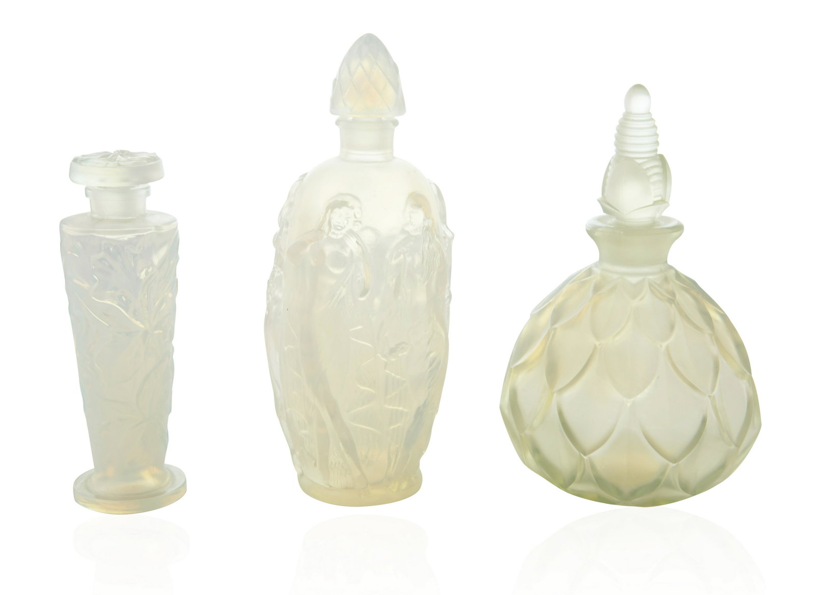 GROUP OF THREE SABINO GLASS PERFUME BOTTLES: GROUP OF THREE SABINO GLASS PERFUME BOTTLES comprising: a) A SABINO GLASS "LA RONDE FLEURIE" PERFUME BOTTLE, after 1931 design the body of elongated form featuring nude women draped in cascading flowe