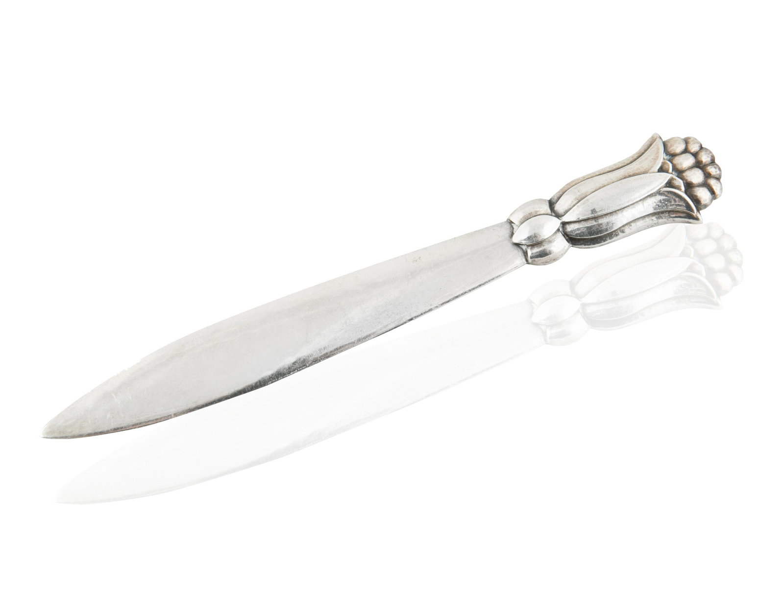 A SILVER GEORG JENSEN LETTER OPENER, 1945: the handle formed as a crocus in bloom, with slender blade, stamped with maker's mark, STERLING DENMARK and numerals 126; length: 16 cm (6 1/4 in.), gross weight: 39.03 g (1.25 ozt) CONDITION The lett