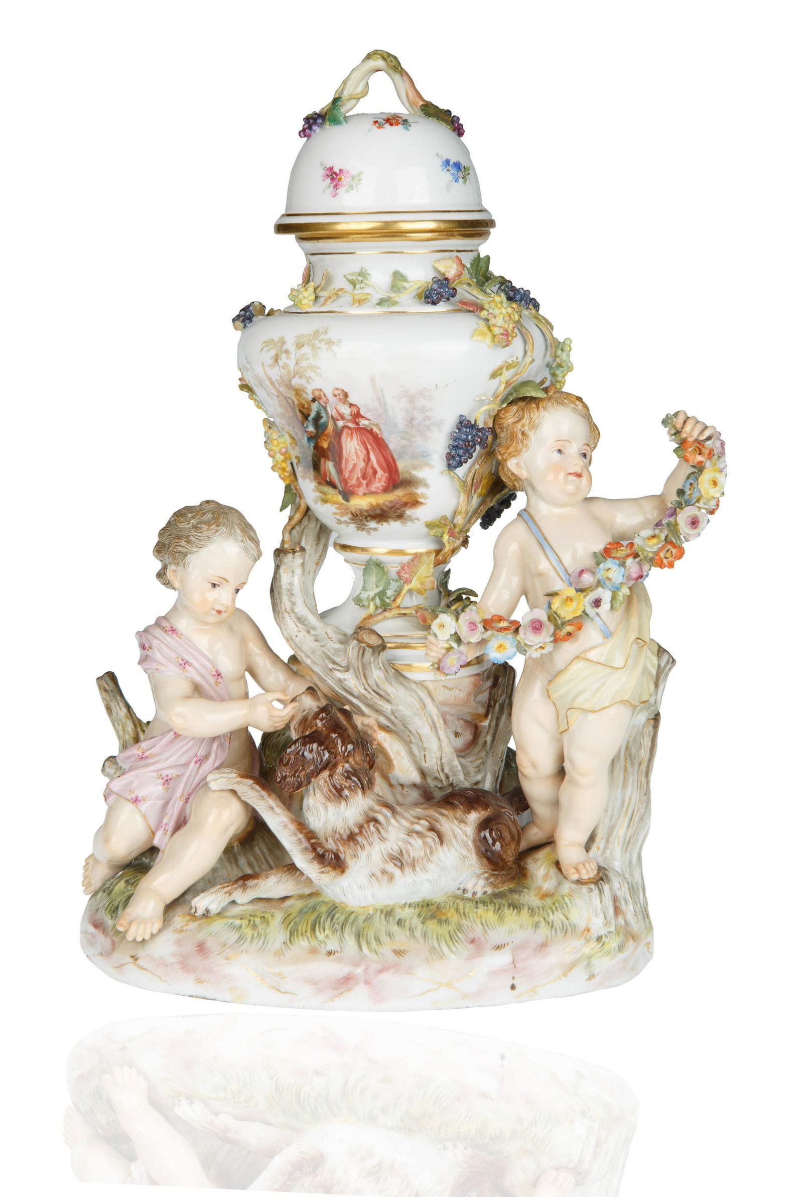 MEISSEN PORCELAIN COVERED URN: mound moulded base with naturalistic applied foliage and vines, centered the covered urn, the body featuring a courting scene with applied leafy grape vine with gilt-edging the cover with conforming d