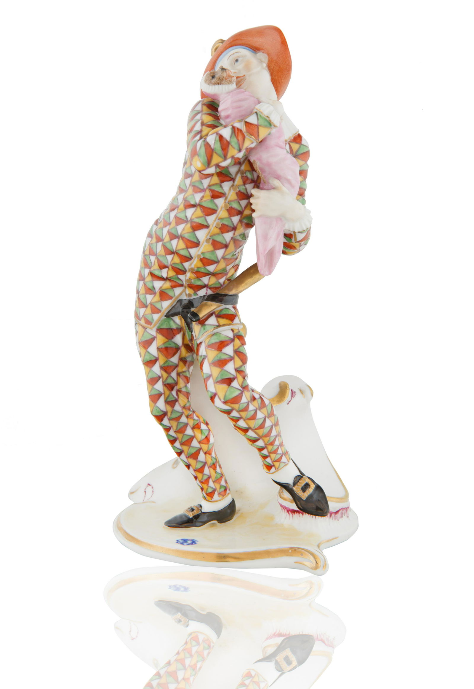 NYMPHENBURG 'HARLEQUIN' PORCELAIN FIGURE: modelled after Franz Anton Bustelli, based on Italian Commedia dell'Arte 'Pulcinella Figure', on a gilt-edged, scroll moulded base, with lace mauve detailing, positioned in a slightly exaggerated pose