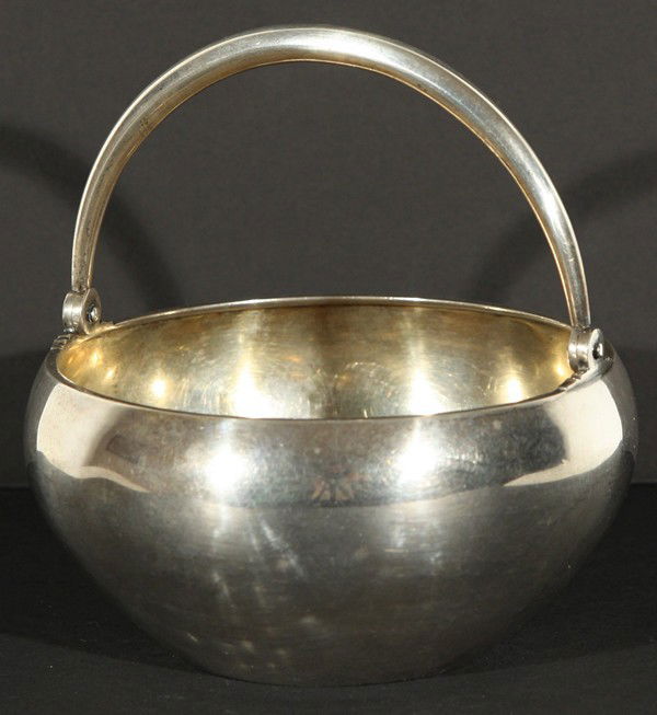 A RUSSIAN SILVER BOWL, GRACHEV, ST. PETERSBURG C.18: A RUSSIAN SILVER BOWL, GRACHEV, ST. PETERSBURG C.1889, with articulated handle, diameter: 13 cm (5 1/8 in.), inscribed on the base in Cyrillic with the Grachev hallmark and assayer's mark of 'A.F.' wi