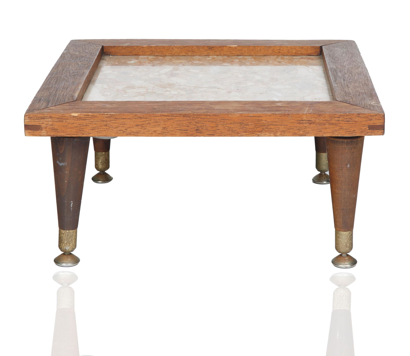 A PETITE MID-CENTURY WOOD AND GRANITE STAND: A PETITE MID-CENTURY WOOD AND GRANITE STAND squat and square inset with a pink and red stone, the legs with brass capped legs, MADE IN ITALY stamped inside of base; height: 19 cm (7 1/2 in.), tabletop