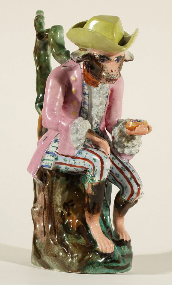 IMPERIAL PORCELAIN MANUFACTORY RUSSIAN ANTIQUE FIGURE: A PORCELAIN FIGURE OF AN ARISTOCRATIC MONKEY, Imperial Porcelain Factory, St. Petersburg, period of Nicholas I (1825-1855), the stopper in the form of a hat, gaily painted throughout; height: 22.5 cm