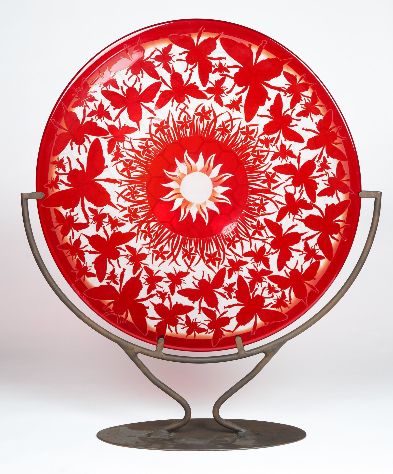 DUNCAN MCCLELLAN (AMERICAN B.1955 )ART GLASS CHARGER: DUNCAN MCCLELLAN (AMERICAN B.1955 )ART GLASS CHARGER a large red Duncan McClellan glass charger with, signed, comes with an iron stand; diameter: 62 cm (24 3/8 in.)