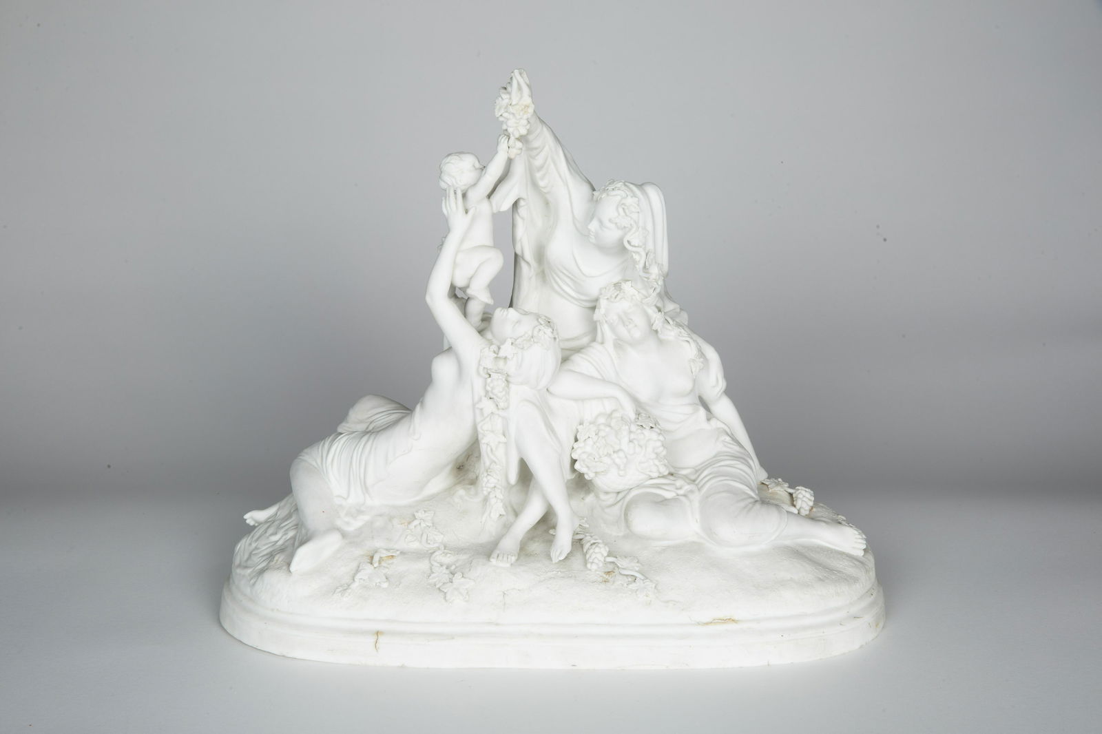 A BISQUE GROUP OF 3 WOMEN AND A PUTTO (1 of 2)