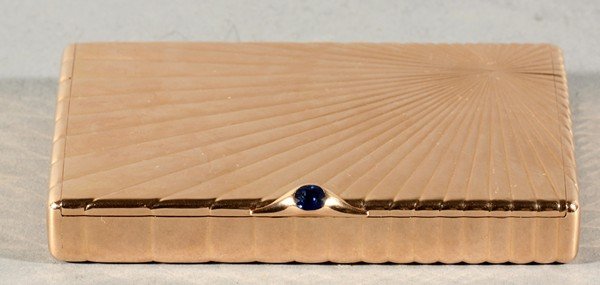 FABERGE ANTIQUE RUSSIAN GOLD AND SAPPHIRE CIGARETT: A GOLD FABERGE CIGARETTE CASE WITH A SAPPHIRE, 1880-1915, a gold cigarette case with a sunburst design reeding from a corner, thumb-piece set with a faceted sapphire, engraved with 'Zoe' on edge, leng