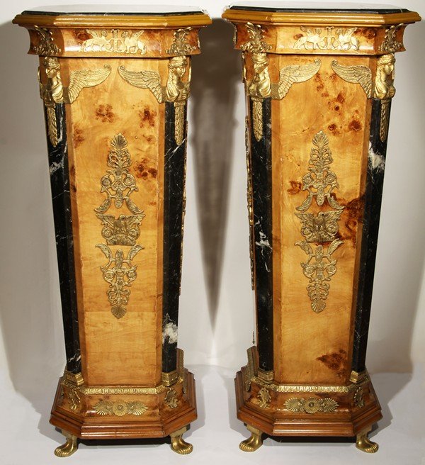 BIRCH AND MARBLE MOUNTED PEDESTALS: A PAIR OF BIRCH AND MARBLE MOUNTED PEDESTALS, in Empire style, of octagonal shape, mounted with a marble top and marble panels on each of the four shorter sides, applied gilded metal winged women's bu