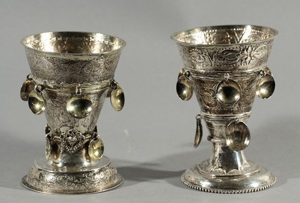PAIR OF ANTIQUE RUSSIAN SILVER BEAKERS: A PAIR OF ANTIQUE EUROPEAN SILVER AND SILVER-PLATE BEAKERS, each decorated with rows of hanging medallions. a) silver beaker features bands of chased and repoussé flowers; b) silver-plate beaker feat