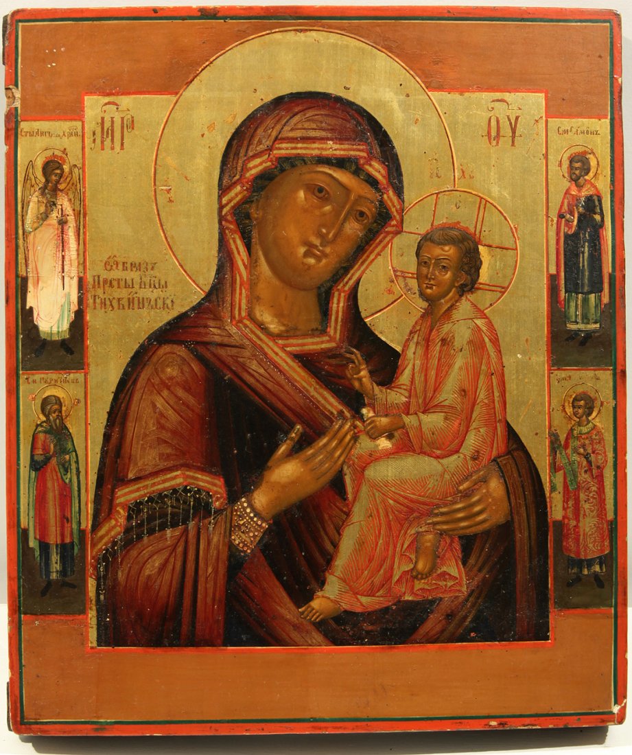 A RUSSIAN ICON OF THE TIKHVIN MOTHER OF GOD, CENTR: A RUSSIAN ICON OF THE TIKHVIN MOTHER OF GOD, CENTRAL RUSSIA, CIRCA 1800, Egg tempera, gold leaf and gesso on wood panel, the back with hand-carved inscriptions. 33.5 x 28.7 cm (13 1/8 x 11 1/4 in.)