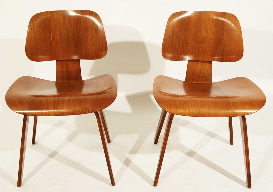 A PAIR OF HERMAN MILLER MOLDED PLYWOOD LOUNGE CHAI: A PAIR OF HERMAN MILLER MOLDED PLYWOOD LOUNGE CHAIRS, 1950s, DCW, the classic chair designed by Charles and Ray Eames, 73 x 49.5 x 50 cm (28 ¾ x 19 1/9 x 19 ¾ in.), marked 'DCW' on the bottom, a lab