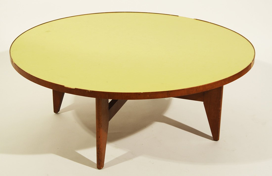 A LOW ROUND KNOLL COFFEE TABLE, 1960s, the yellowi: A LOW ROUND KNOLL COFFEE TABLE, 1960s, the yellowish-green top supported by four crossed legs, diameter: 102 cm. (40 ¼ in.), a Herman Miller label affixed to the bottom of the table top. THIS LOT IS 